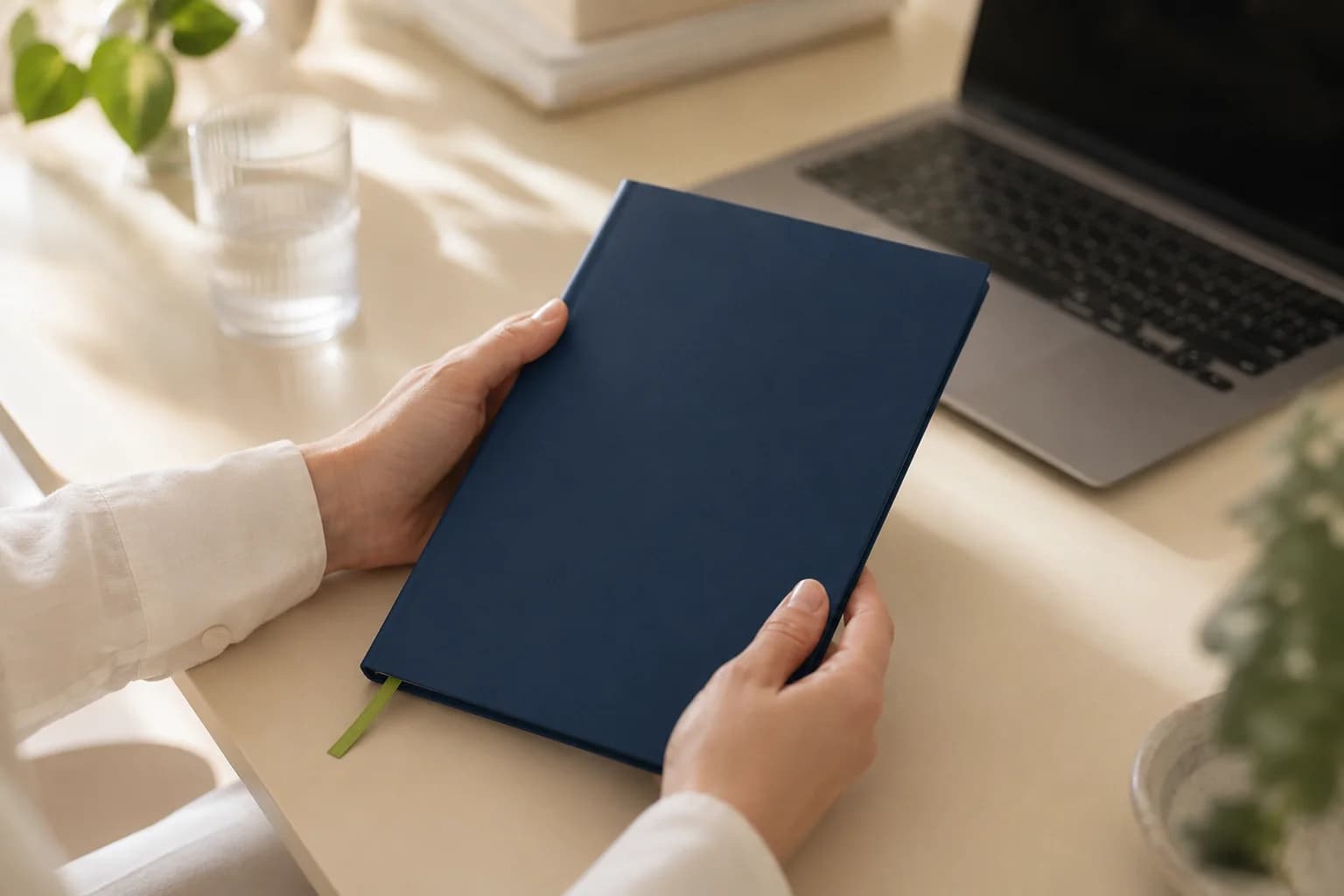 A client holding the visibility playbook next to their laptop